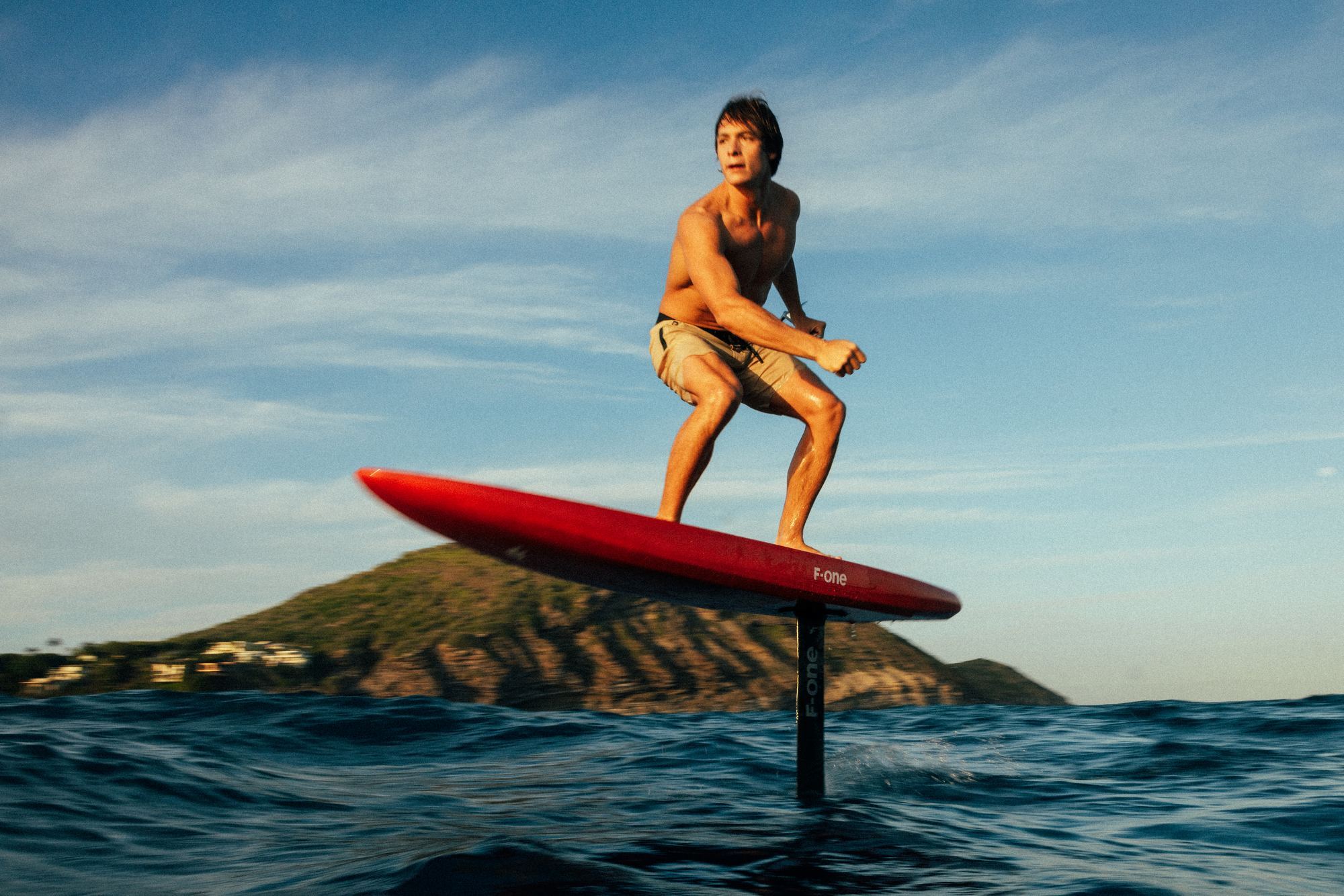 Athlete foilboarding on red F-ONE board