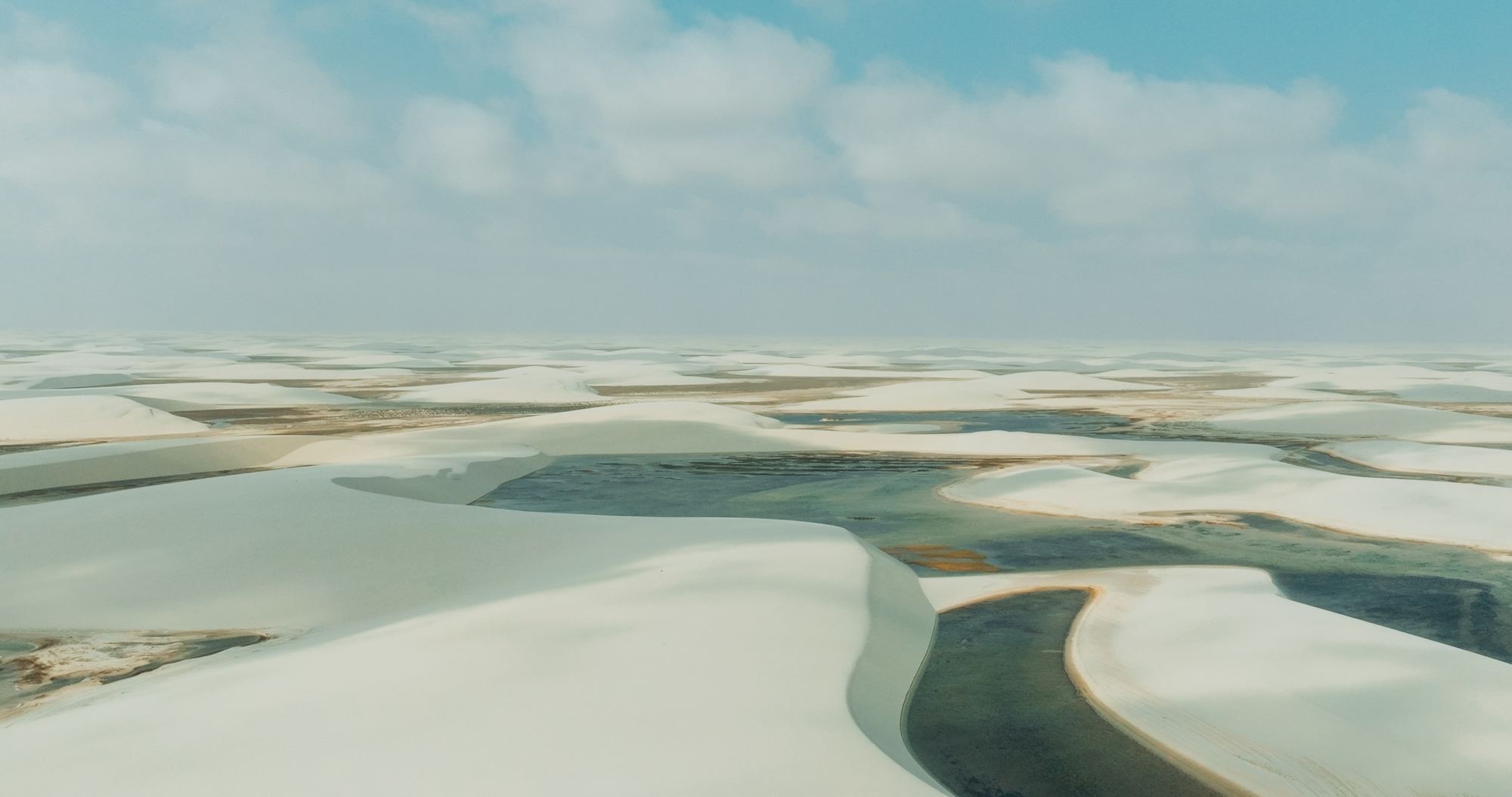 Aerial view of white sand dunes and turquoise lagoons Brazil